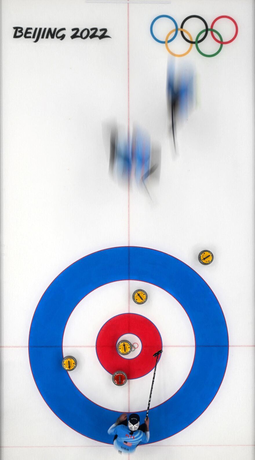 USA's Chris Plys (bottom) guides the team during the mens round robin session 3 game of the Beijing 2022 Winter Olympic Games curling competition between Great Britain and USA, at the National Aquatics Centre in Beijing on February 11, 2022.